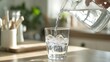 © Somphong - 6. A transparent drinking glass being filled with water from a pouring jug in a bright kitchen
