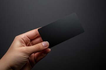 Leinwandbilder - Sleek black gift card held in hand with empty space for custom text on dark background. Generative AI