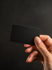 Leinwandbilder - Elegant black gift card held by a hand against a dark background with ample space for adding personalized text or logo. Generative AI