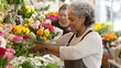 © dvoevnore - Latin american mature florist woman creates bouquet of flowers in flower store