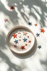 Poster - clean flat lay of scattered stars and stripes decorations displayed on smooth white ceramic plate under soft natural