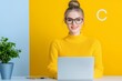 © serdon - A happy businesswoman in glasses at work in the office. A young, good-looking female worker using a modern laptop.