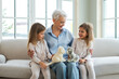 © Юлия Завалишина - Happy family at home. Two little girls sisters twins grandmother enjoying time together. Good time at home. Grandma granddaughters child kids playing toys hugging together. Family generations