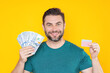 © Volodymyr - Business man with money banknotes. Male entrepreneur with dollar bills. Lucky boss, insurance agent, manager. Freelancer with cash. Mock up, for yellow banner with copy space.