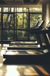 © StockUp - A serene gym interior featuring treadmills with a beautiful view of nature outside the windows.