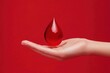 © LimeSky - A hand grips a blood drop against a red backdrop highlighting awareness of blood disorders like anemia and leukemia along with blood donation