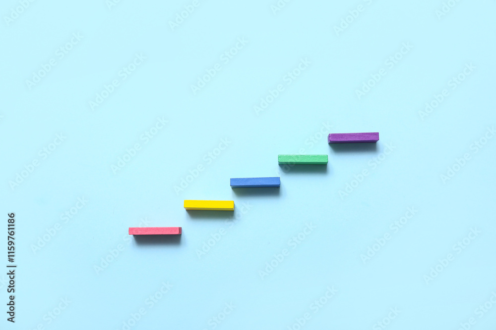 Ladder made of colorful blocks on blue background