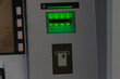 © Alena - A detailed closeup image of an ATM machine, highlighting the card slot along with shining green status indicator lights