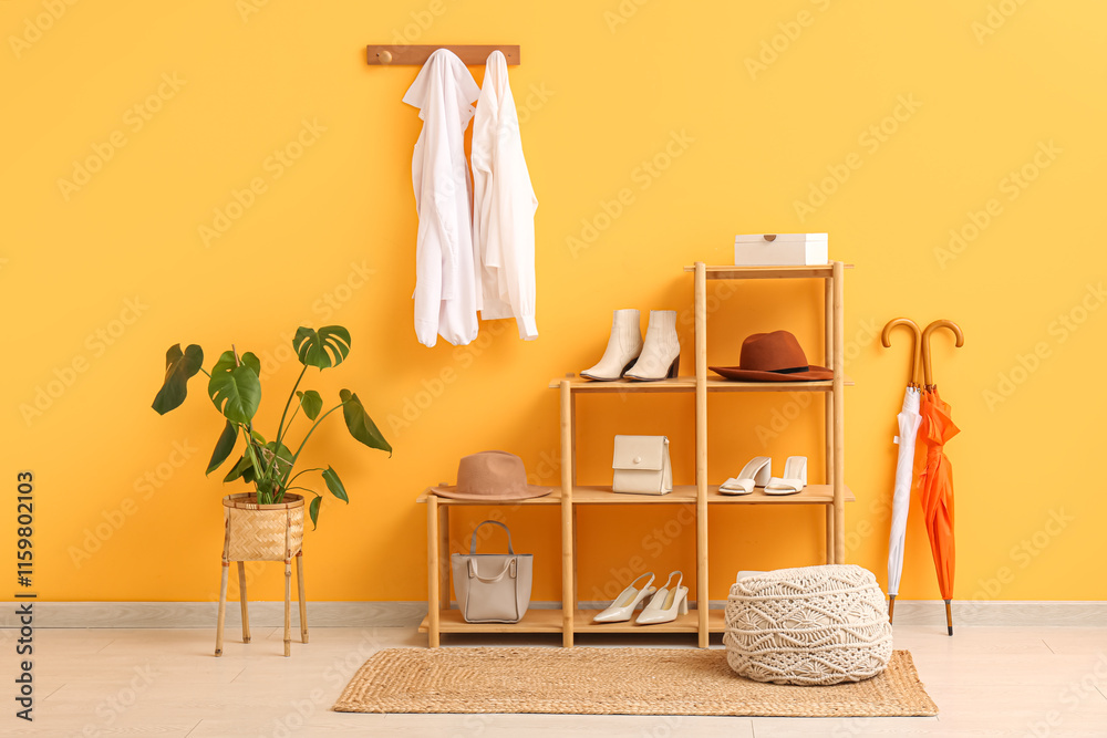 Interior of dressing room with hanging shirts and shelf unit