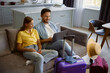 © Nomad_Soul - Happy loving couple planning honeymoon tour searching flight ticket on internet