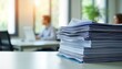 © Maryna - Organized documents stack on office table. Busy office scene with people working in background. Files neatly arranged represent paperwork management. Workplace environment. Business administration.