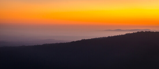 Wall Mural - Sunrise in the mountains, panorama landscape, natural background, Preah Vihear Thailand.Mist in the morning.Aerial view of Morning sunrise above the mountains with mist around , Mountains fog.