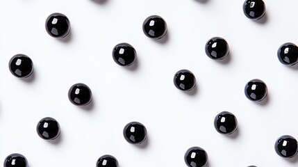 Poster - Black Glossy Beads Arranged in Symmetrical Pattern on White Surface