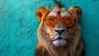 © Bhanuka - A majestic lion wearing orange sunglasses against a green wall, exuding a cool vibe. Perfect portrait with copyspace for creative projects.