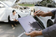 © Witoon - Insurance agents assist clients in an outdoor setting after a car accident, inspecting the vehicle for damage, discussing policy coverage, repair options, liability, and pursuing a claim.