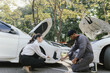 © Witoon - Insurance agents assist clients in an outdoor setting after a car accident, inspecting the vehicle for damage, discussing policy coverage, repair options, liability, and pursuing a claim.