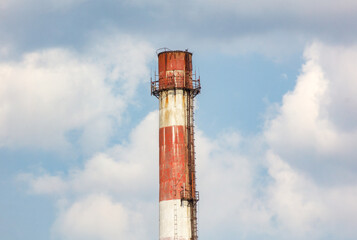 Wall Mural - A tall, rusted, red and white tower with a ladder on it