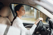 © SHOTPRIME STUDIO - Woman, car, driver, steering wheel a woman sits in the driver's seat of a car, her hand on the steering wheel, looking thoughtfully to the side