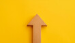 © hardvicore - Minimalist wooden arrow on yellow background. Wood pointer, forward direction, up.