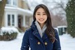 © Lubos Chlubny - Young woman smiling under snowfall in front of house