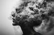 © PD - A woman is captured in profile against a muted background, her head enveloped in a cloud of swirling smoke, creating an ethereal and enigmatic atmosphere.