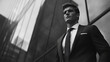 © Loony Dream Designs - Confident man in stylish suit with modern building reflecting ambition sophistication