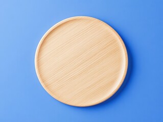 Blank coaster mockup. A simple wooden plate on a blue background, showcasing its natural texture and minimalistic design.