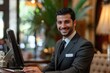 © Dream maker - Professional male receptionist assisting guests at an upscale hotel during daytime business hours