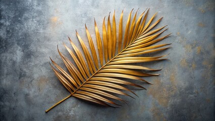 Aufkleber - A single golden palm frond rests on a textured gray surface, showcasing a harmonious blend of natural elegance and minimalist simplicity.