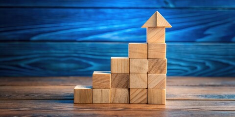 Poster - Wooden blocks arranged in a staircase shape with an arrow at the top symbolizing upward growth and success