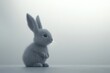 © Nana - A soft gray bunny sits quietly, showcasing its adorable features in a minimalist setting.
