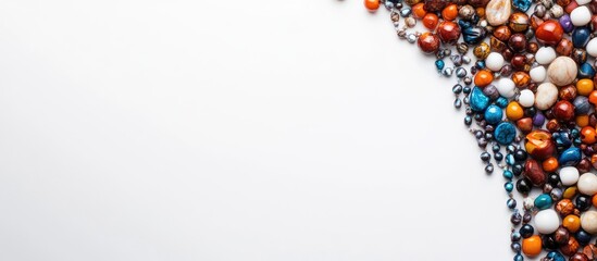 Poster - Colorful assortment of exotic beads arranged stylishly on a white background creating a vibrant space for text and design elements