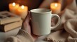 © Александр Бердюгин - A cozy scene featuring a hand holding a steaming cup of coffee, surrounded by books, candles, and soft lighting, evoking warmth and relaxation