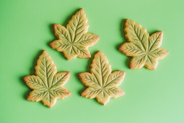 Poster - Freshly baked cookies designed as leaves on a green surface, great for food and baking illustrations