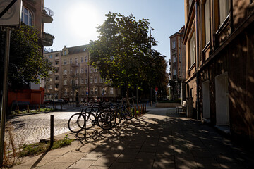 Bicycles Line An Old Street On A Sunny Day, Creating A Picturesque Cityscape In Poznan