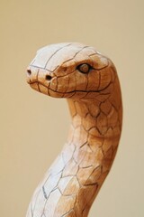 Poster - A detailed shot of a wooden snake statue with intricate carvings and textures