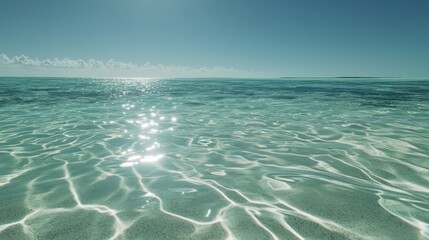 Wall Mural - Tranquil and clear ocean waters reflecting sunlight, a serene paradise. The bright waves dance softly, inviting you to relax by the beautiful shoreline and enjoy nature.