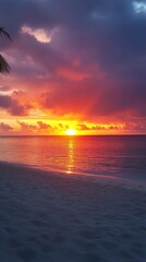 Wall Mural - Stunning sunset at the beach with vibrant colors reflecting on calm waters, creating a perfect view for relaxation and peace.