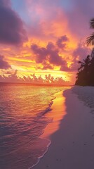 Wall Mural - Stunning tropical sunset over the ocean, creating a beautiful reflection on the sandy beach. Palm trees line the shore as colorful clouds fill the sky.