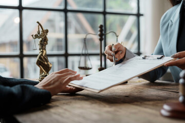 Wall Mural - Lawyer holding contract and showing client where to sign, with scales of justice and gavel on desk