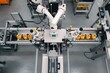 © Viktoriia - Automated assembly line featuring robotic arms and precision mac