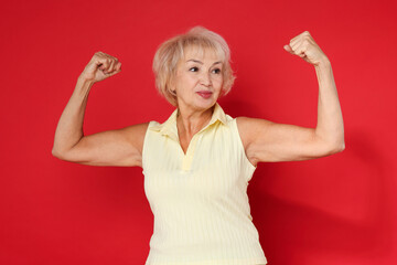 Sticker - Senior woman exercising on red background. Healthy lifestyle