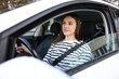 © New Africa - Driver behind steering wheel of modern car, view from outside