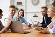 © New Africa - Group of people using different gadgets at wooden table in office. Modern technology
