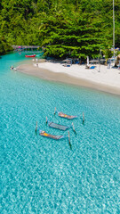 Wall Mural - Crystal clear waters lap gently at the shore, where sunbathers float on hammocks, soaking up the serene atmosphere of Koh Kood. A couple in a hammock in the ocean