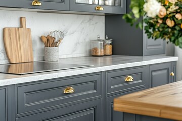 Modern kitchen countertop with gray cabinets, marble backsplash, and wooden utensils.