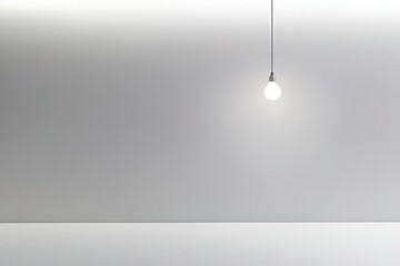 Poster - single light bulb suspended from ceiling its soft glow illuminating simple empty space