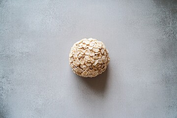 Poster - single scoop of oatmeal resting symmetrically on smooth matte surface under diffused natural lighting