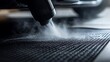 © CreativeAi - A vacuum cleaner nozzle removing dust from black car floor mats