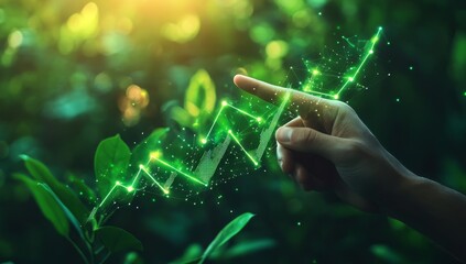 Wall Mural - Hand pointing at glowing green upward graph, nature background.